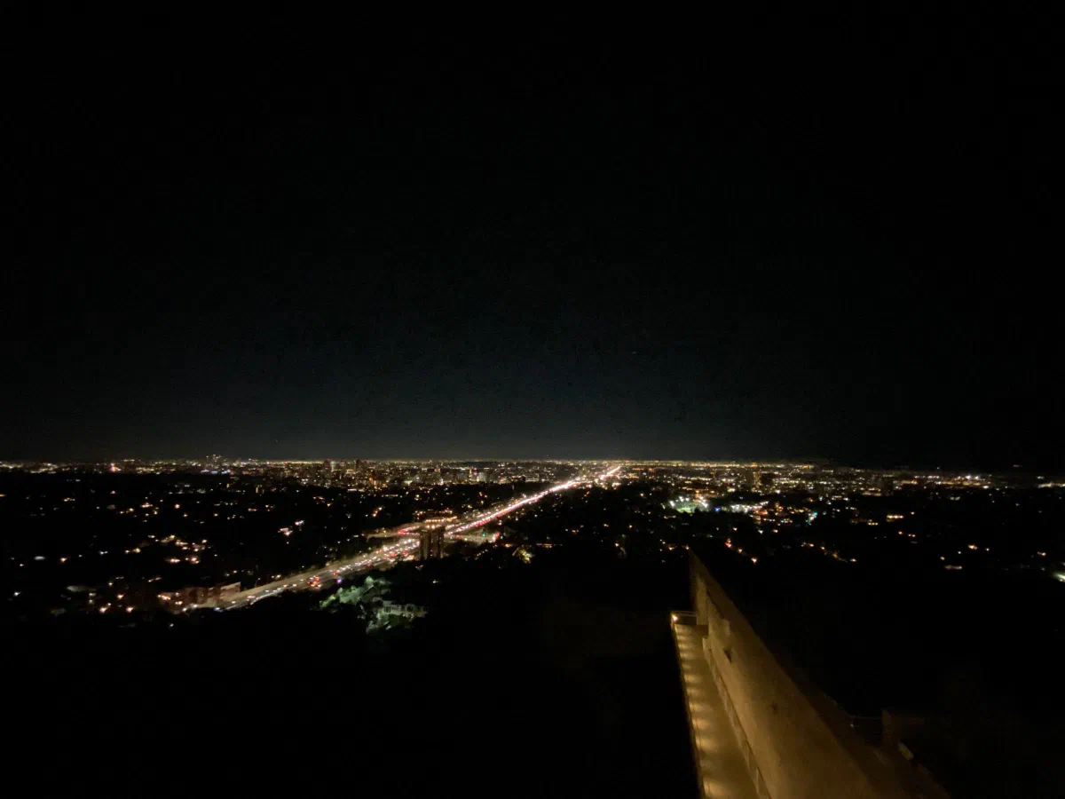 A long straight avenue of lights stretching through a city at night.