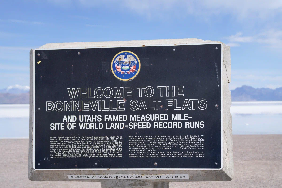 A welcome sign for the Bonneville Salt Flats against an open, pale landscape.