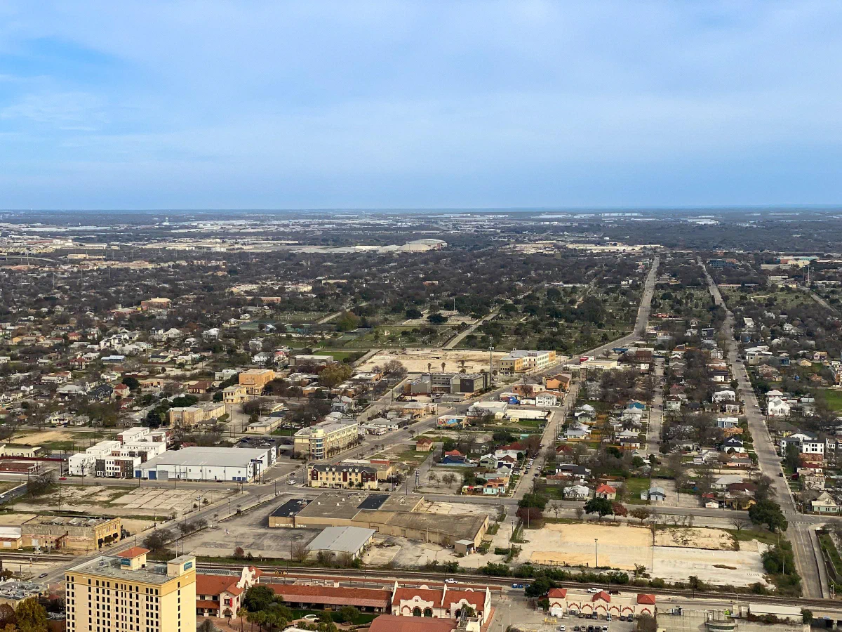 A broad city panorama with a long straight road extending toward the horizon.